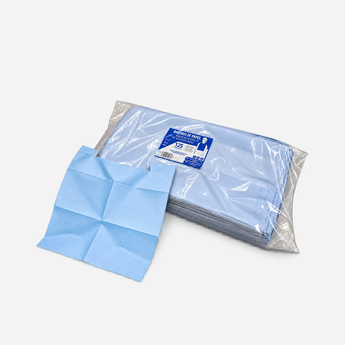 Paquete de 125 baberos de papel con bolsillo para adultos junto a una unidad abierta mostrando su formato y acabado.