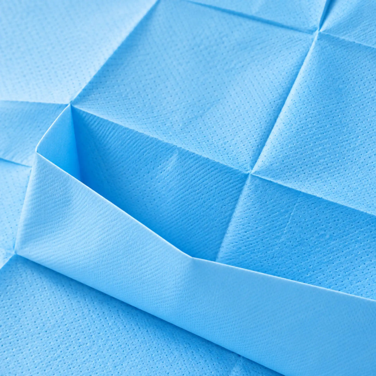 Plano detalle del babero desechable de papel y polietileno, con composición de 14,5 g/m² de papel y 12 g/m² de polietileno.