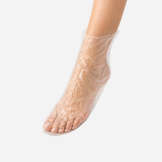 Pie cubierto con un calcetín desechable durante un tratamiento profesional de pedicura en Gran Canaria